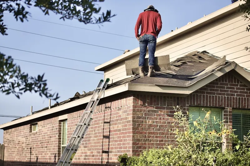 Professional roofer working on a residential roof in Nauck